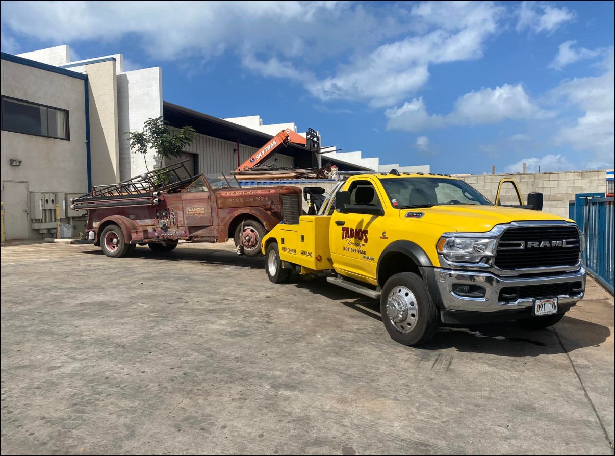 Tadio's tow truck on a Honolulu street during the day